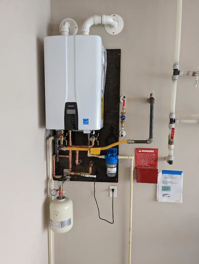 Professional plumber installing copper piping in a Kent home